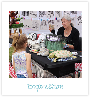 Peggy talking to a child at the Sun Art Fair with a caption of "Expression"