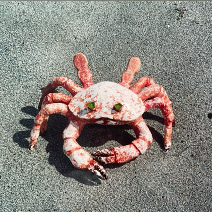 Scurry the crab sculpture with green sea glass eyes.